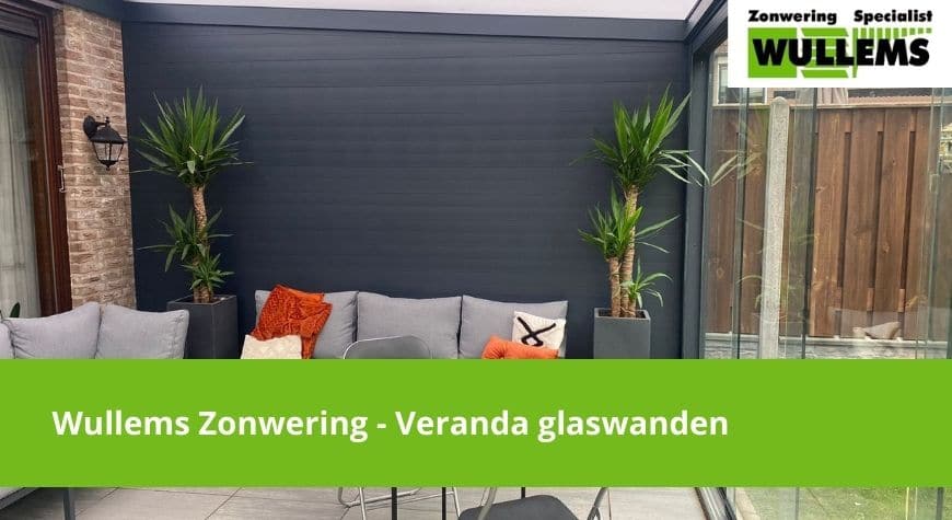 Op deze foto is een veranda voorzien van een glaswand te zien.